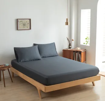 Zijaanzicht bamboe hoeslaken Space Blue (kleur donker blauw) op een bed